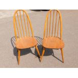 A pair of Ercol Quaker elm and beech dining chairs.