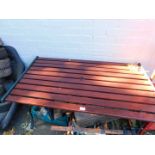 A cast iron and hardwood garden table.