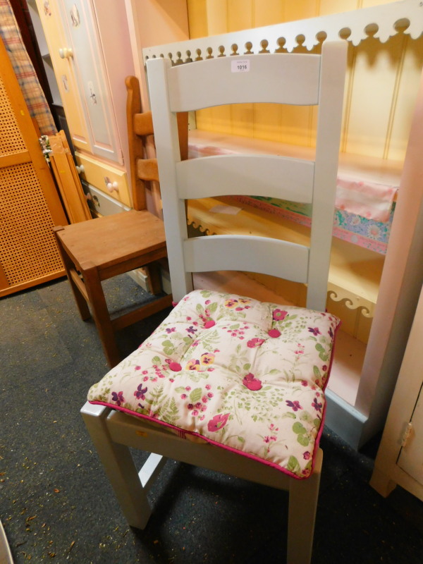 A turquoise painted wooden ladder back chair, with solid pine seat and loose tied cushion.