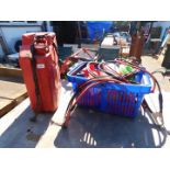A red jerry can, two petrol cans, various strimmer line and a pair of jump leads. (quantity)
