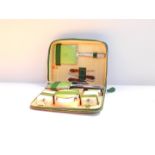 A vintage 1950's "Two-Tix" green cloth cased vanity set, containing hair brush and comb, ointment
