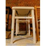 A pair of white painted wooden kitchen stools, with brown leatherette seats, 53cm H.