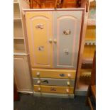 A painted pine tallboy,with two doors opening to reveal a single adjustable shelf, over three