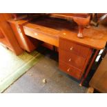 An Austin Suite 1950's teak dressing table, with a rectangular mirror flanked by two oval mirrors,