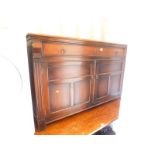 An early 20thC oak and burr walnut sideboard, with three short drawers, one fitted for cutlery,