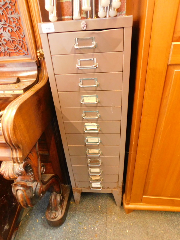 A grey steel twelve drawer filing cabinet, raised on bracket feet, 98.5cm H, 29cm W, 42cm D.