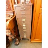 A grey steel twelve drawer filing cabinet, raised on bracket feet, 98.5cm H, 29cm W, 42cm D.