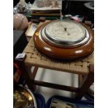 An oak footstool, 30cm W, together an oak circular wall barometer by Harris of Spalding, 28cm