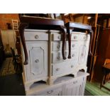 A Georgian style cream painted wooden break front sideboard, with four central graduated drawers,