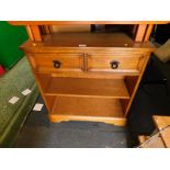 A light oak open bookcase, with two drawers over a single shelf, raised on bracket feet, 80cm H,