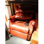 An HSL red leather recliner armchair, with red fabric arm rest protectors, 74cm W.