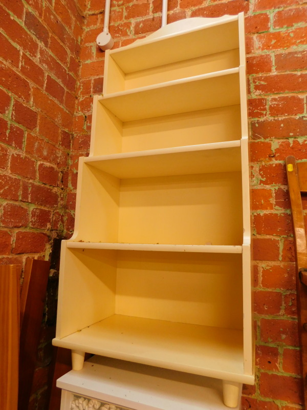A yellow painted wooden waterfall bookcase, of three shelves, raised on turned feet, 124cm H, 46.5cm