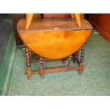 An early 20thC oak gateleg dining table, raised on barley twist supports, 44cm wide, 114cm extended,