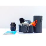 A Praktica MTL3 camera, with a Pentacon auto 1.8-50 lens, together with a Carl Zeiss zoom lens MCS