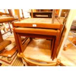 A 1970's Danish teak nest of occasional tables, each with four floral tiled insets, largest 46cm