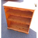 A pine open bookcase, of two shelves, raised on a plinth bracket feet, 96cm H, 80cm W, 33cm D.