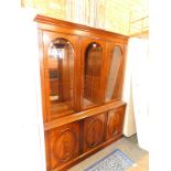 A reproduction mahogany display cabinet, with three arched glazed doors over three cupboard doors,