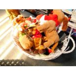 A wicker basket containing animated musical Christmas soft toys.