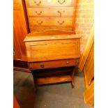 A mid 20thC student's oak bureau, the fall flap opening to reveal five recesses, over a frieze