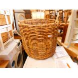 A wicker twin handled log basket, of cylindrical form, 52cm H.
