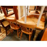 A pine and white painted farmhouse kitchen table, with an end frieze drawer raised on turned legs,