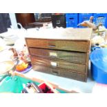 A faux skin bound four drawer stationery chest, 25.5cm high, 38cm wide, 24cm deep.