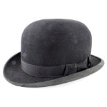 A G.A. Dunn & Sons bowler hat, in black with ribbon bow, 12cm high, interior measurements 21cm x