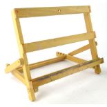 A beech table easel, with adjustable action, 45cm wide.