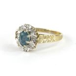 A 9ct gold dress ring, florally set with oval claw set central stone, surrounded by small