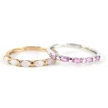 A ladies half eternity ring, set with pink stones, marked 9K, another gold dress ring set with