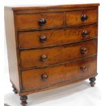 A Victorian mahogany bow fronted chest, of two short and three long cockbeaded drawers, on double