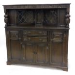A Reprodux style oak court cupboard, with rectangular top held on heavy baluster supports, with a