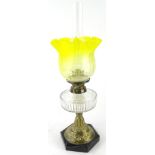 An early 20thC oil lamp, with clear funnel marked fire proof, with bear stamp, yellow clear and