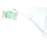 A metal framed Anglepoise magnifier, with industrial sized glass, 33cm wide, in white.