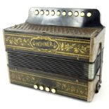 An early 20thC Hohner Marca accordion, with meshwork grill front, four upper and ten lower