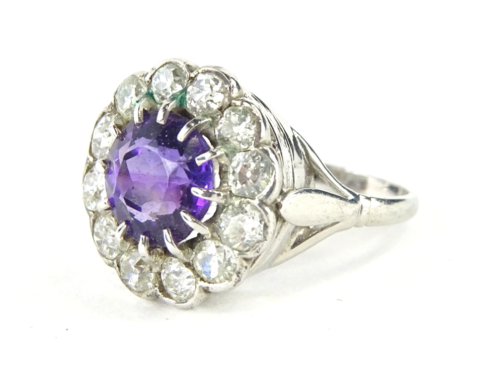 A floral cluster dress ring, set with amethyst and diamonds, florally claw set with a central