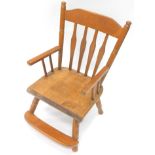 A 20thC child's beech chair, with curved cresting rail, vertical back splat, plain arms and foot