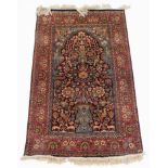 A Kashan style Tree of Life rug, of rectangular form, the outer style with a repeat geometric