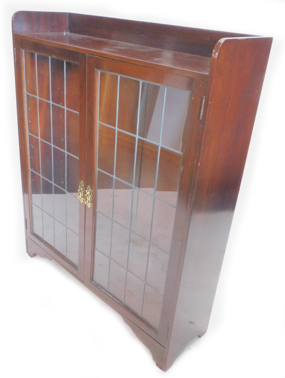 A mahogany bookcase, with a raised back above two leaded glazed doors on bracket feet, 103cm wide.