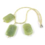 A necklace, set with three large sections in polished jade colour, with a sectional necklace, each