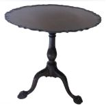 A mahogany occasional table, the circular pie crust top on a baluster shaped turned column, with