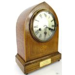 A 20thC oak cased mantel clock, the mitre shaped case on a rectangular base, terminating in orb
