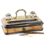 A Victorian walnut and brass ink stand, with two moulded glass inkwells and a frieze drawer