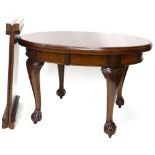 An Edwardian mahogany extending dining table, the oval top with a moulded edge on cabriole legs with