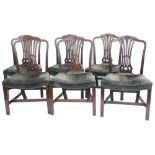 A set of six George III mahogany dining chairs, each with a pierced splat and a padded seat on