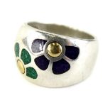 A modern silver dress ring, with design of two flowers in green and purple, with silver hallmark and