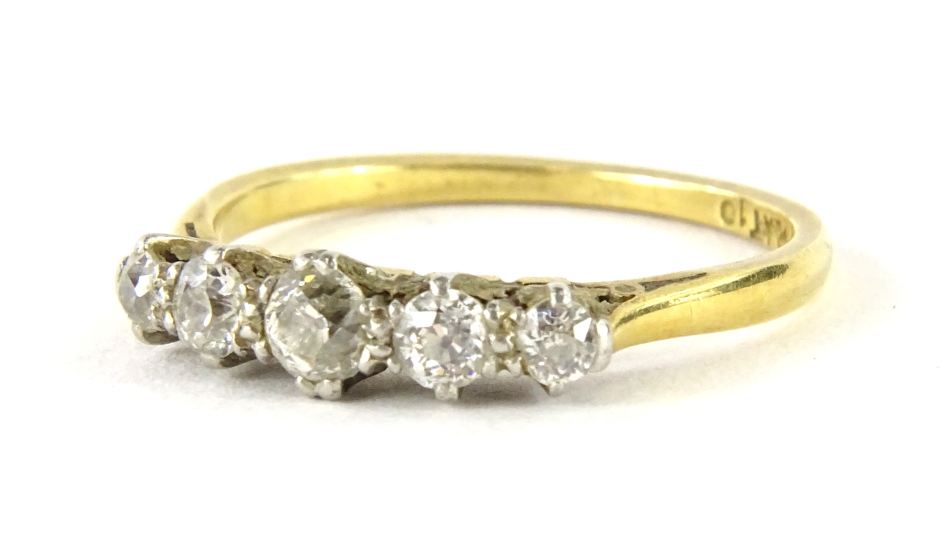 A five stone diamond ring, set with graduated round brilliant cut diamonds, approx 0.10cts