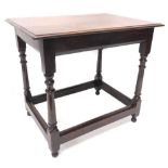 An oak side table, the rectangular plank top on a turned column with stretchers, constructed from