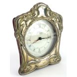 R Carr. An Elizabeth II silver fronted mantel clock, the shaped case with an Art Nouveau design