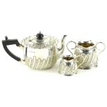 A Victorian silver three piece tea service, comprising teapot, the shaped lid with gadrooned